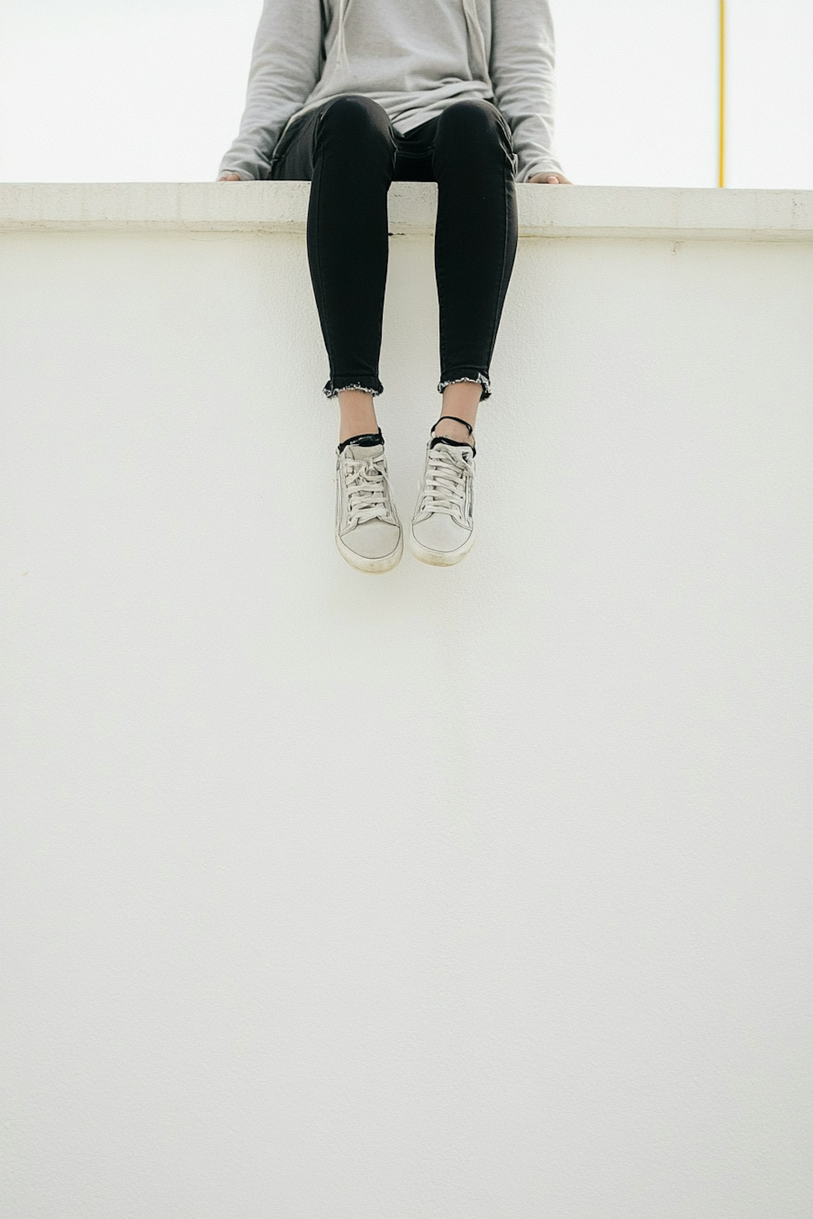 Girl is sitting on a gate
